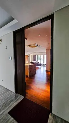 an open door to a living room with a kitchen at 2 Bedroom Urban Oasis Poblacion in Manila