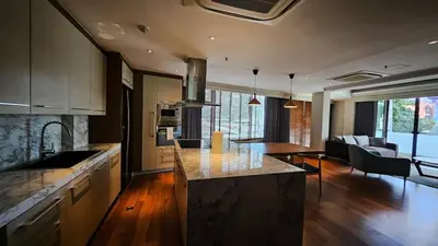 a kitchen and living room with a counter top at 2 Bedroom Urban Oasis Poblacion in Manila