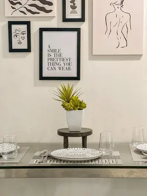 a table with a vase of flowers on top of it at La Luana Mnl in Manila