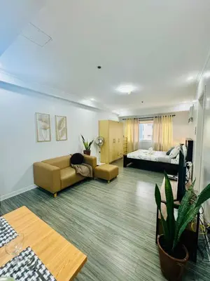 a living room with a couch and a bed at Cozy Haven in Manila