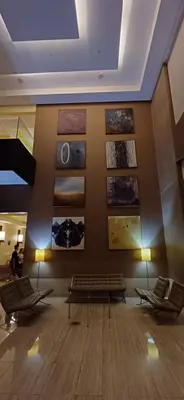 a lobby with benches and pictures on the wall at Cozy Haven in Manila