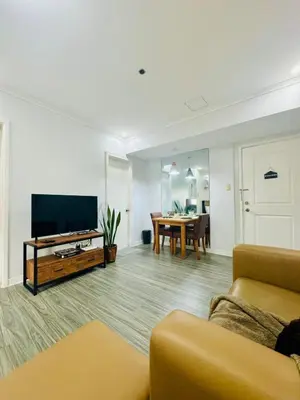 a living room with a couch and a television at Cozy Haven in Manila