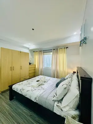 a large bed in a bedroom with a window at Cozy Haven in Manila