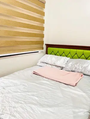 a bed with a pink towel on top of it at Von Home Sweet Home in Dasmariñas