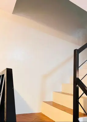 a set of stairs in a room with white walls at Von Home Sweet Home in Dasmariñas