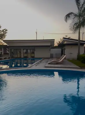 a swimming pool in front of a house at Von Home Sweet Home in Dasmariñas
