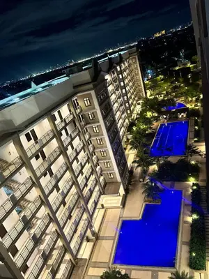an aerial view of a building with a pool at night at YourSafeHaven Calathea Place Lavender Bldg in Manila