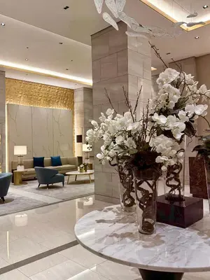 a lobby with a vase of flowers on a table at Tres Casa in Manila