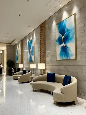 a lobby with couches and a painting on the wall at Tres Casa in Manila