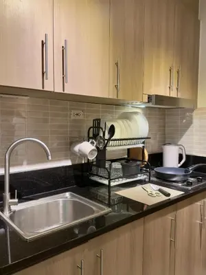 a kitchen with a sink and a counter top at Tres Casa in Manila