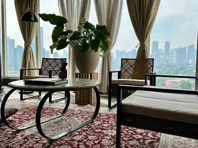 a room with a bed and a table and a window at 55-SQM Urban Cabin in Poblacion Makati in Manila