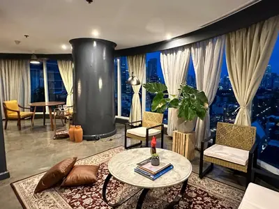 a living room with a view of a city at 55-SQM Urban Cabin in Poblacion Makati in Manila