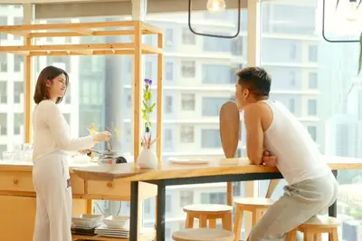 a man and a woman standing at a table at 55-SQM Stunning View Wood House Poblacion Makati in Manila