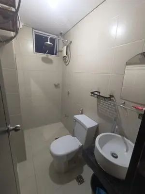 a bathroom with a toilet and a sink at Affordable Condo Staycation at San Lorenzo place condominium in Manila