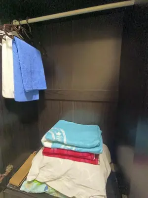 a pile of folded towels on a shelf in a closet at Affordable Condo Staycation at San Lorenzo place condominium in Manila