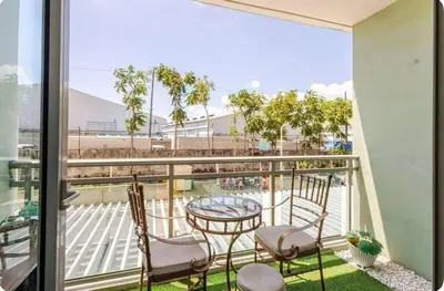 a balcony with a table and chairs and a view at Homesweethome Beach Resort in Manila