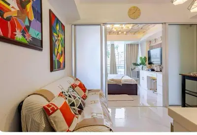 a living room with a couch and a television at Homesweethome Beach Resort in Manila