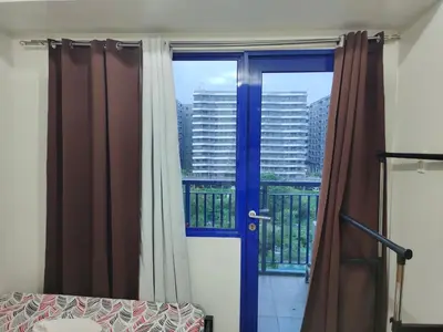 a room with a door and a window with a view at Sea Residences, Pkwy, Pasay City 1300, Philippines in Manila