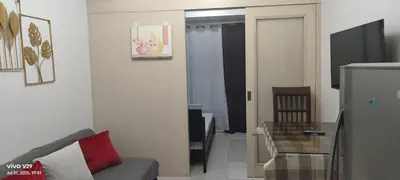 a living room with a couch and a glass table at Sea Residences, Pkwy, Pasay City 1300, Philippines in Manila