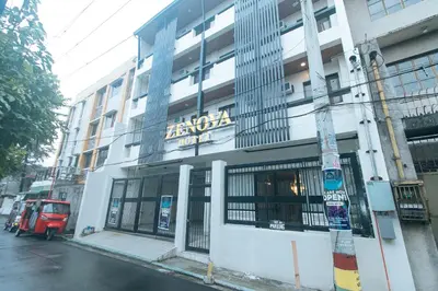 a building with a sign on the side of it at RedDoorz at Zenova Hotel in Manila