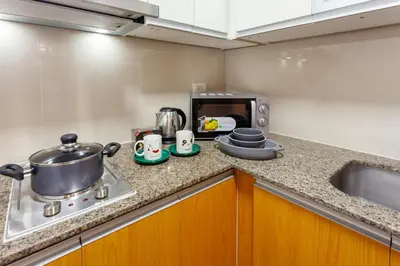 a kitchen counter with pots and pans on a stove at Luxurious & Elegant Vibe in Newport City Pasay in Manila