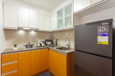 a kitchen with a sink and a refrigerator at Luxurious & Elegant Vibe in Newport City Pasay in Manila