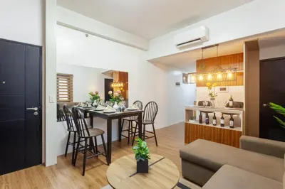 a living room and kitchen with a table and chairs at Luxurious & Elegant Vibe in Newport City Pasay in Manila