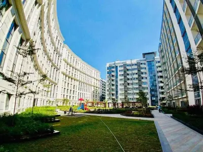 a large building with a park in front of it at Luxurious & Elegant Vibe in Newport City Pasay in Manila