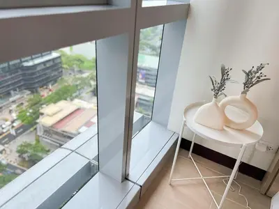 a white table with two vases on it next to a window at Stylish 1BR Prime BGC Uptown near Hyatt #upt119c in Manila