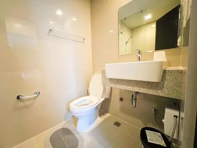 a bathroom with a toilet and a sink at Stylish 1BR Prime BGC Uptown near Hyatt #upt119c in Manila