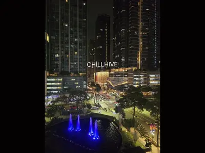 a view of a city at night with blue fountains at Stylish 1BR Prime BGC Uptown near Hyatt #upt119c in Manila