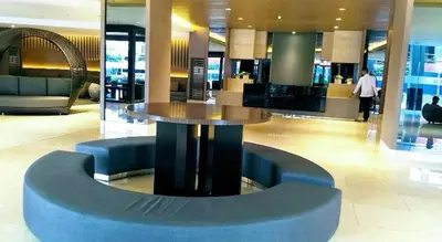 a lobby with a circular table in a building at Hotel De Rama Unit 1230 near MOA & NAIA in Manila