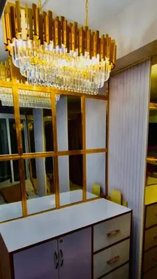 a chandelier hanging over a dresser in a room at Hotel De Rama Unit 1230 near MOA & NAIA in Manila