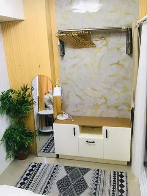 a bedroom with a bed with a desk and a mirror at Hotel De Rama Unit 1230 near MOA & NAIA in Manila