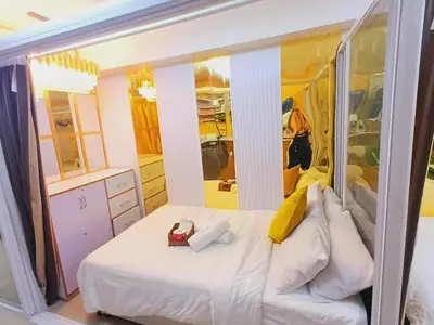 a small bedroom with a bed and a mirror at Hotel De Rama Unit 1230 near MOA & NAIA in Manila