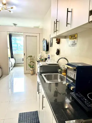 a kitchen with a sink and a counter top at V&G Era Staycation in Manila