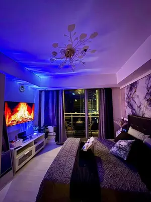 a bedroom with a large bed with a purple ceiling at Dream Escapade in Manila