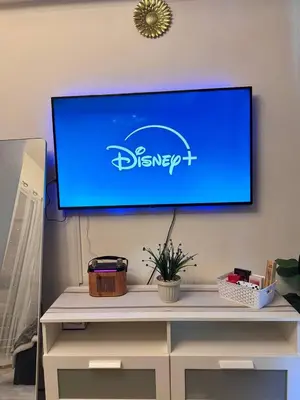 a flat screen tv on a wall above a desk at Dream Escapade in Manila
