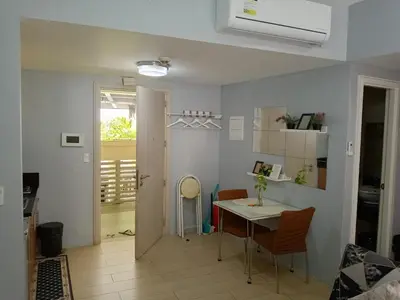 a kitchen and dining room with a table and chairs at Jentry condotel in Manila