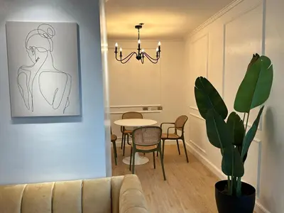 a living room with a couch and a table at Chic Urban Stay with Balcony & Bathtub in Poblacion in Manila