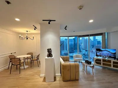 a living room with a couch and a table at Chic Urban Stay with Balcony & Bathtub in Poblacion in Manila