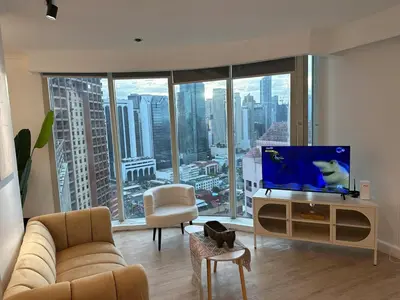 a living room with a tv and a large window at Chic Urban Stay with Balcony & Bathtub in Poblacion in Manila