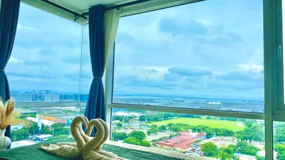 two swans sitting on a table in front of a window at Stunning view staycation near MOA PICC WORLD TRADE CENTER AIRPORT LUNETA PARK MANILA OCEAN PARK QURINO GRANDSTAND in Manila
