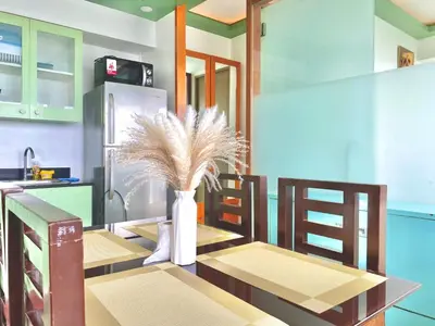 a kitchen with a table and a vase with a plant at Stunning view staycation near MOA PICC WORLD TRADE CENTER AIRPORT LUNETA PARK MANILA OCEAN PARK QURINO GRANDSTAND in Manila