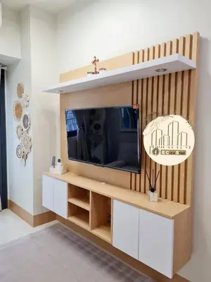 a living room with a flat screen tv on a entertainment center at EcityStay in Manila