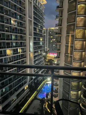 a view of a city at night from a balcony at Azure Bali Verde-1Bedroom pool view in Manila