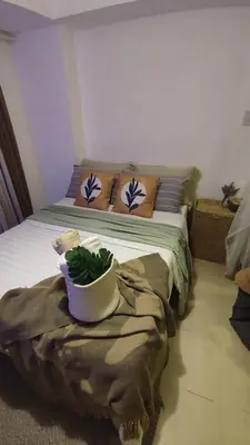 a bedroom with a bed with a plant on it at Azure Bali Verde-1Bedroom pool view in Manila