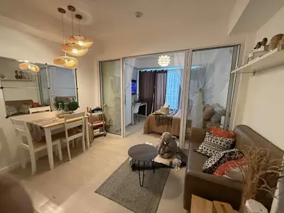 a living room with a couch and a table at Azure Bali Verde-1Bedroom pool view in Manila