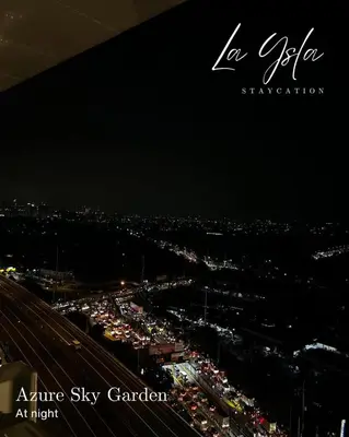 a view of a city at night with traffic at Azure Bali Verde-1Bedroom pool view in Manila