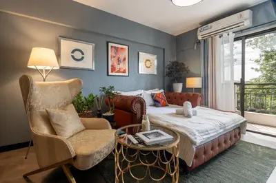 a bedroom with a bed and a chair at Boutique one-bedroom apartment near airport, business hubs in Manila